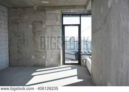 An Inside View Of An Empty Newly Constructed Apartment, Flat Without Repair With A Window Installed 