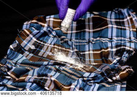 Concept Poisoning Of An Oppositionist A Hand In A Blue Protective Glove Pours White Powder On The Fl