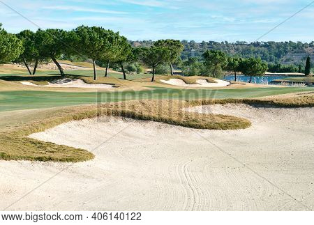 Picturesque Scenery Golf Course Green Field With Trees And Blue Lake During Warm Winter Sunny Day, M