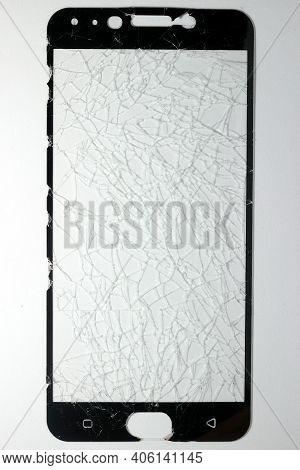The Phone's Screen Protection Film Is Completely Broken And Rests On A White Background.