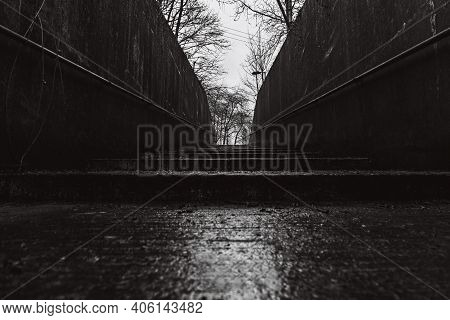 A Black And White Street Photography Style Image Of Urband Concrete Wide Steps On A Wet And Overcast