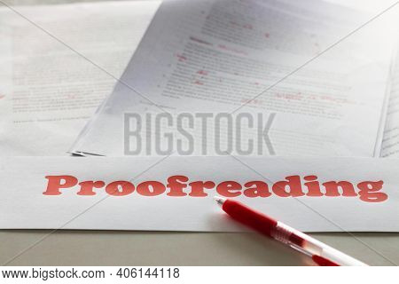 Red Proofreading Sign Over Blurred Paperwork On White Table Represents Proofreading Service