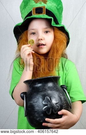 Enchanting Smiling Small Girl In Green Clothes With Decorative Red Beard In Leprechaun's Hat Showing