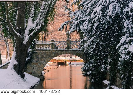 Manor Park In Iłowa In Winter. A Brick Bridge Over The Czerna Mała River.\nthe Town Of Iłowa In West