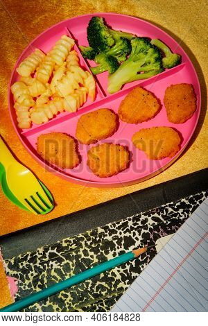 At Home Schooling Chicken Nugget Lunch Served On Tray With French Fries And Broccoli