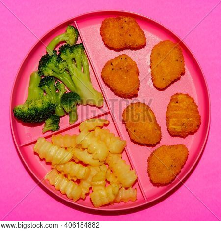 At Home Schooling Chicken Nugget Lunch Served On Tray With French Fries And Broccoli