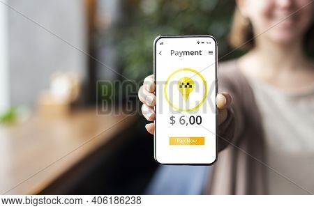 Closeup Of Young Woman Showing Modern Mobile Taxi App On Cellphone Screen, Ordering Cab Online, Payi
