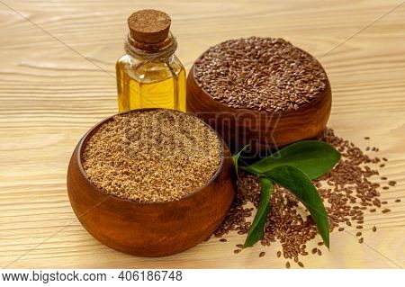 Flaxseeds In A Spoon And Bowl With A Bottle Of Flaxseed Oil And Flaxseed Flour