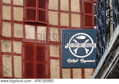 BAYONNE, FRANCE - CIRCA DECEMBER 2020: Les Tontons Flingueurs restaurant sign. The name comes from a movie from the same name.