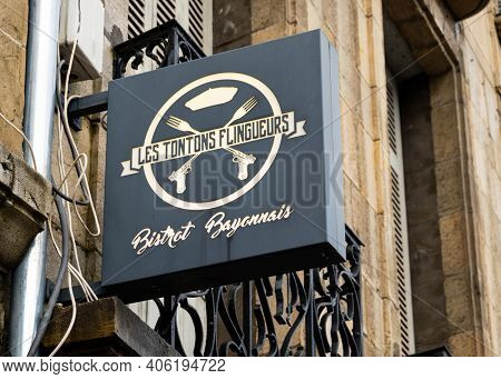 BAYONNE, FRANCE - CIRCA DECEMBER 2020: Les Tontons Flingueurs restaurant sign. The name comes from a movie from the same name.