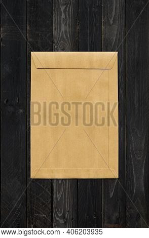 Large A4 Brown Paper Enveloppe Mockup Template Isolated On Black Wood Background