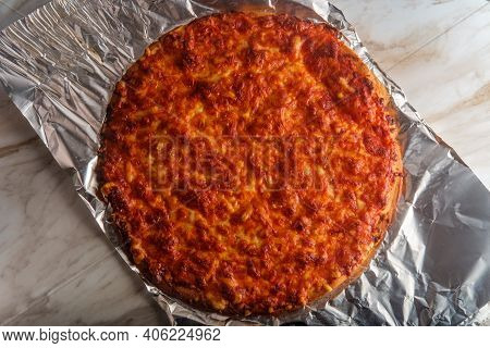 Unsliced Crispy Nyc Style Pizza Pie On Tin Foil