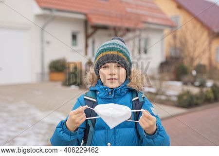 Kid Boy Wearing Ffp Medical Mask On The Way To School. Child Backpack Satchel. Schoolkid On Cold Aut