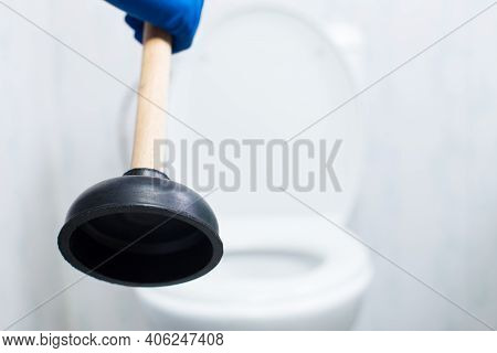 Cleaning Clogg In Toilet With Ventuz, Close Up. Plumbing Service With Plunger Close-up.