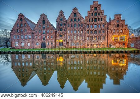 The Historic Salzspeicher Reflecting In The Trave River At Dawn, Seen In Luebeck, Germany