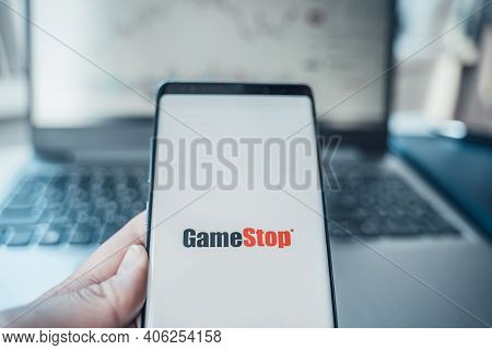 Russia Moscow 02.02.21 Mobile Phone With Logo Of Gamestop In Hand. Company Making Video Games. Playi