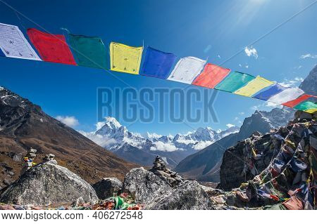 Holy Buddhist Praying Multicolored Flags With Mantras Flapping And Waving On The Strong Wind With Va