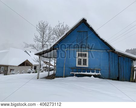Wooden House In The Village In Winter. An Old Wooden Building By The Forest. Village House In The Mo