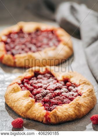 Two Perfect Raspberry Galettes. Delicious Rustic Homemade Tart With Frozen Or Fresh Raspberries On G