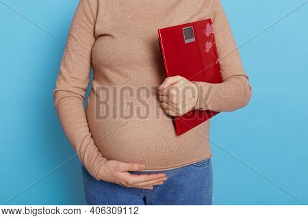Weight Gain During Pregnancy, Pregnant Woman Holding Scale, Faceless Future Mommy Against Blue Backg