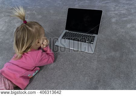Cute Little Blonde Caucasian Baby Girl Laying At Gray Rug And Watching At Laptop, Modern Digital Gen