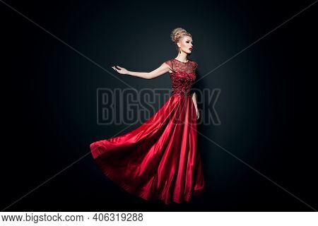 Fulll Length Image Of A Wonderful Young Woman Dressd In A Long Fluing Red Dress With Raised Hands, O