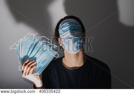 Man With Face Masks In Shadows. Bad Man Making Money.