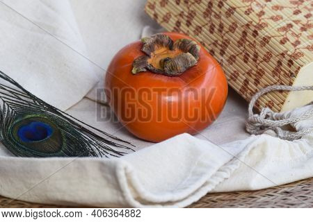 Persimmon Fruit On Black Plate With Woven Bamboo Type Background . Fresh Organic Produce Farm Fresh 