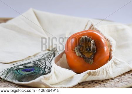 Persimmon Fruit On Black Plate With Woven Bamboo Type Background . Fresh Organic Produce Farm Fresh 