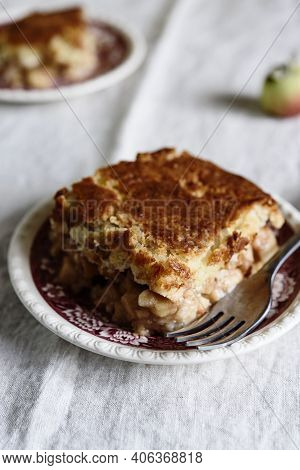 Apple And Cheese Cobbler Crisp. Cobbler Or Crumble Dessert With Apples On Plates On Beige Linen Tabl