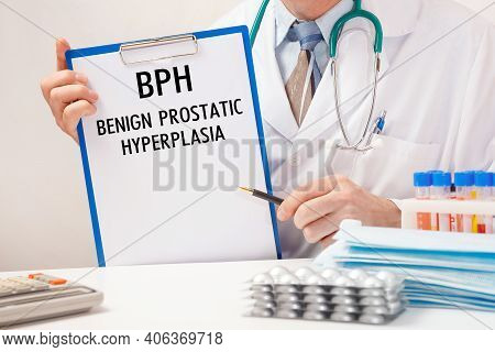 Doctor Holds Paper With Inscription Bph - Benign Prostatic Hyperplasia, Stethoscope And Pills On Tab