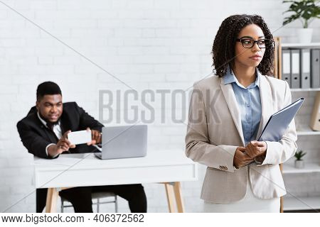 Sexual Molestation At Workplace. Perverted Black Guy Taking Photo Of His Female Coworker Without Her