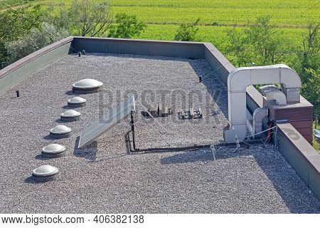 Ventilation Air Duct Solar Panel Skylight Windows At Gravel Flat Roof