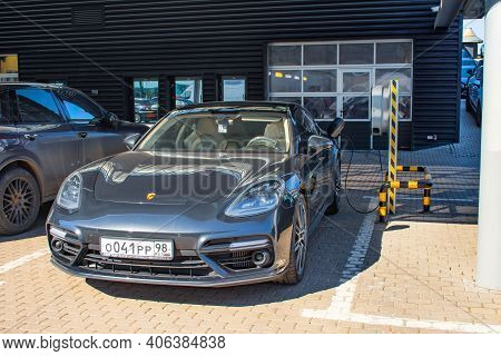Porsche Turbo Hybrid Electric Car Charging With High Power Charging Technology. Russia, Saint-peters