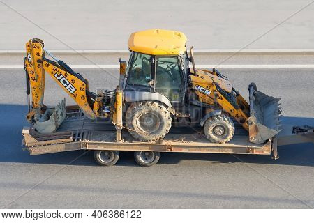 Jcb 3cx Machinery A Tractor With A Bucket At The Back And Front For Digging Is Transported On A Trai