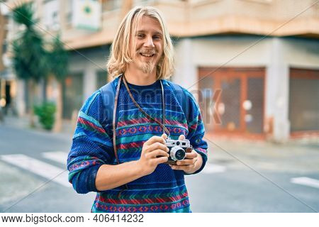 Young scandinavian tourist man smiling happy at the city.