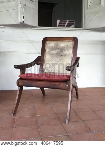 Classic Antique Wooden Chair With Mesh Backrest And Red Cushion. Front View Of Colonial Solid Wood A