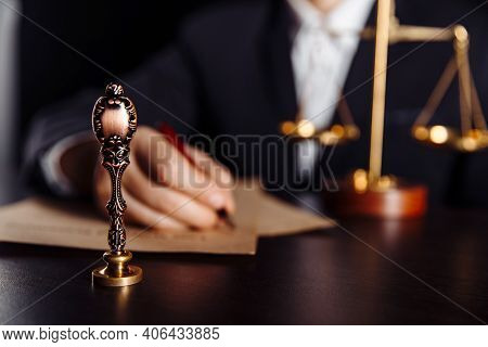 Man Signing A Last Will And Testament Document In Notary Public Office. Stamp In Focus