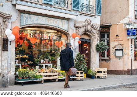 Strasbourg, France - Feb 14, 2019: Man Walking Near Fleurs Broglie La Fleuristerie Florist Store Sho