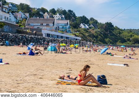 Plerin, Brittany, France - 24 August 2019: People Sunbathing On Sandy Atlantic Beach La Plage Des Ro