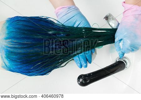 Top View Of Hairdresser In Gloves Washes Clients Head With Long Hair Sapphire Color After Hair Color