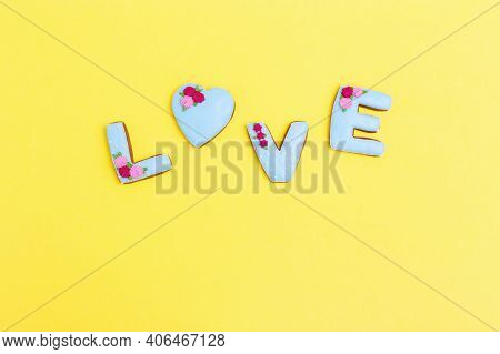 Inscription Love By Homemade Cookies On Yellow Background With Copy Space. Holiday Concept For Weddi