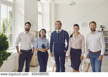 Successful Smiling Business People Coworkers Standing And Looking At Camera In Office