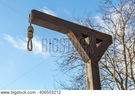 Wooden Gallows On The Background Of Branches And Sky
