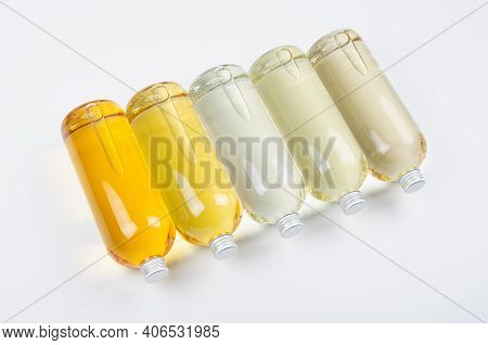 Collection Transparent Lying Bottles With Different Pale Colors Liquid, Cosmetic Product, Perfume Or