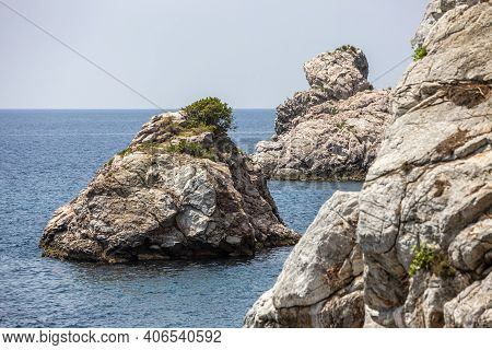 Big Rock In The Blue Waters Of Stafilos Beach, Skopelos, Skopelos Island, Greece.