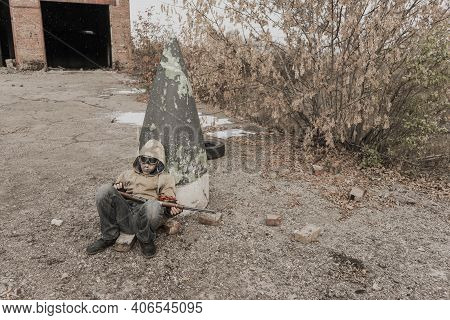 Wandering Boy. Boy With A Gun. Boy Goes To An Abandoned Building. Boy Stands In Front Of A Building.