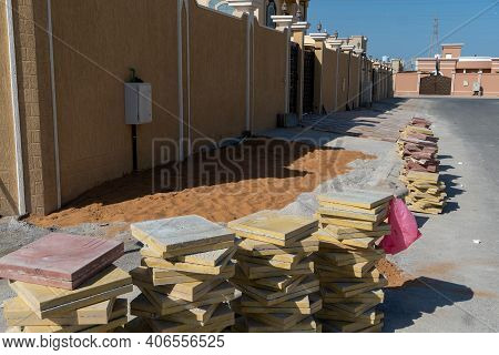 Home Renovation Of Concrete Sidewalk Tiles Ourside Entrance Way Of New Home With Piles Of Tiles And 
