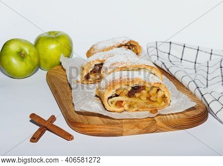 Apfelstrudel With Cinnamon On Cutting Board On White Background