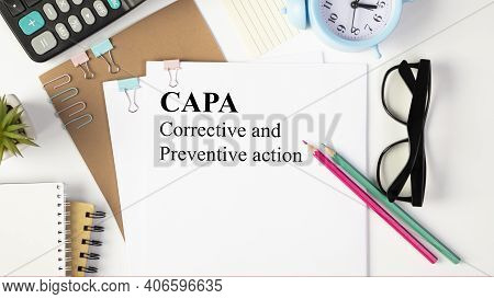 Paper With Corrective And Preventive Capa Action Plans On A Table